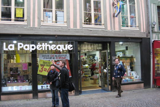 Shop on street with big clock in Rouen