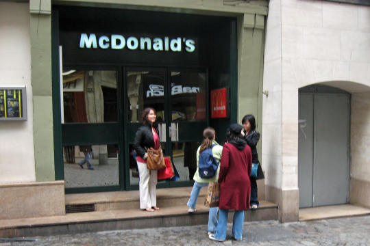 McDonalds on street with big clock in Rouen